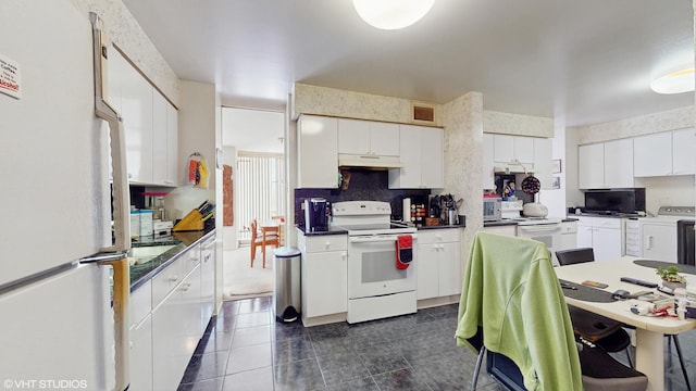 601 E 32nd St Unit 210, Chicago, IL 60616 - kitchen with white appliances, under cabinet range hood, backsplash, white cabinetry, and dark tile patterned floors