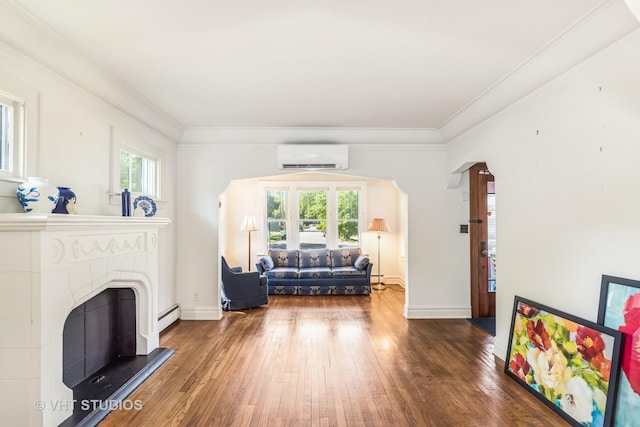 1620 Hyde Park Ave, Waukegan, IL 60085 - living room with a wall mounted air conditioner, wood-type flooring, ornamental molding, a fireplace with raised hearth, and a baseboard radiator