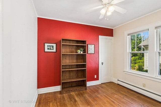 1620 Hyde Park Ave, Waukegan, IL 60085 - empty room featuring a baseboard heating unit, wood finished floors, crown molding, and a ceiling fan