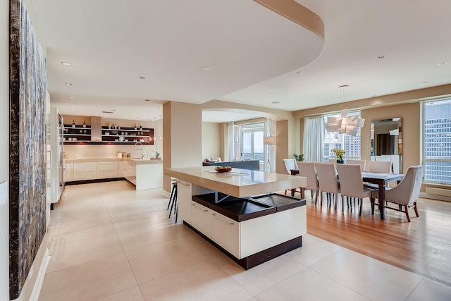 270 E Pearson St Unit 1402, Chicago, IL 60611 - dining space featuring light tile patterned floors, a chandelier, arched walkways, and recessed lighting