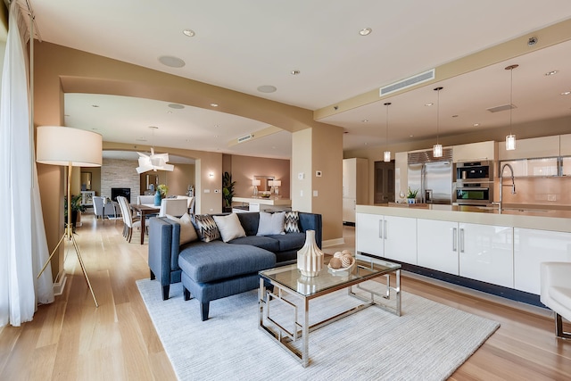 270 E Pearson St Unit 1402, Chicago, IL 60611 - living area with light wood-style floors, arched walkways, and recessed lighting