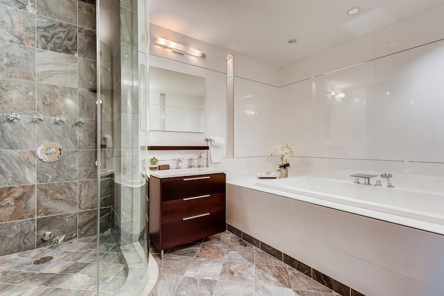 270 E Pearson St Unit 1402, Chicago, IL 60611 - bathroom featuring vanity, a garden tub, and a stall shower