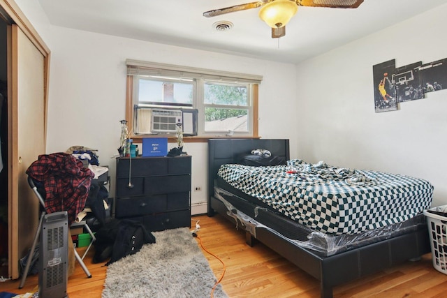 949 E 170th St, South Holland, IL 60473 - bedroom with light wood-style flooring, cooling unit, a baseboard heating unit, and ceiling fan