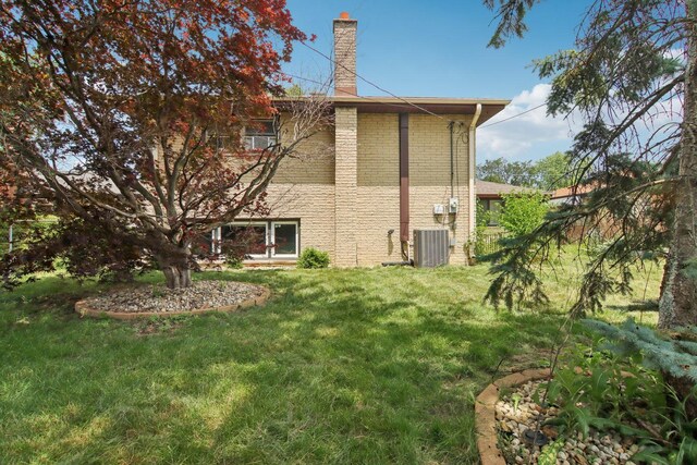 949 E 170th St, South Holland, IL 60473 - rear view of property with a chimney, a yard, and brick siding