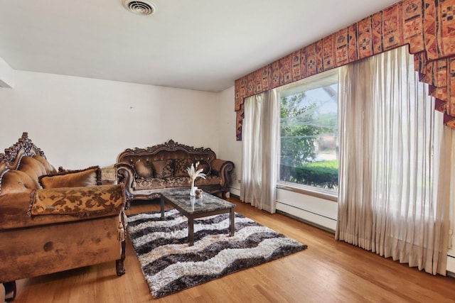 949 E 170th St, South Holland, IL 60473 - living area featuring wood finished floors and a baseboard heating unit