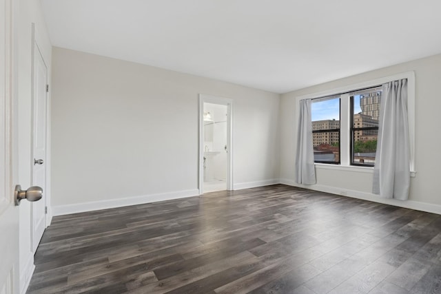 1755 E 55th St Unit 503, Chicago, IL 60615 - empty room with dark wood finished floors and baseboards