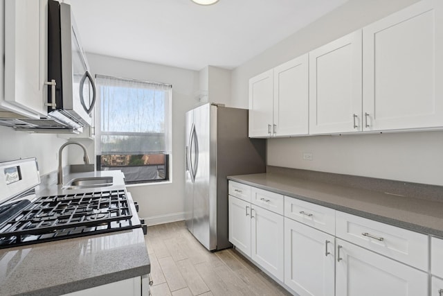 1755 E 55th St Unit 503, Chicago, IL 60615 - kitchen featuring stainless steel appliances, white cabinetry, dark stone counters, and light wood finished floors