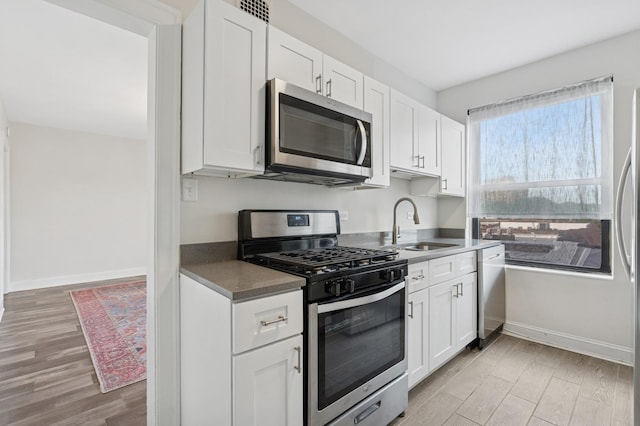 1755 E 55th St Unit 503, Chicago, IL 60615 - kitchen with stainless steel appliances, light wood-type flooring, and white cabinets
