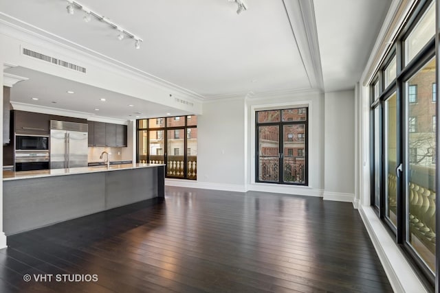 2550 N Lakeview Ave Unit N204, Chicago, IL 60614 - unfurnished living room with track lighting, dark wood-type flooring, and crown molding
