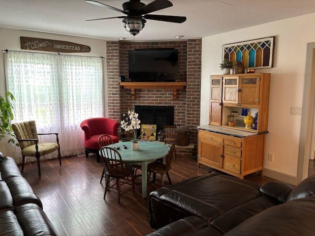 1591 N 2700 E Rd, Sheldon, IL 60966 - living room with dark wood-style flooring, ceiling fan, and a brick fireplace