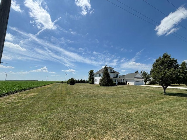 1591 N 2700 E Rd, Sheldon, IL 60966 - view of green lawn featuring a garage, driveway, and a view of countryside