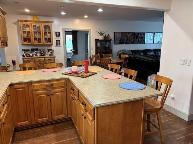 1591 N 2700 E Rd, Sheldon, IL 60966 - kitchen with a breakfast bar area, dark wood-type flooring, glass insert cabinets, brown cabinets, and open floor plan