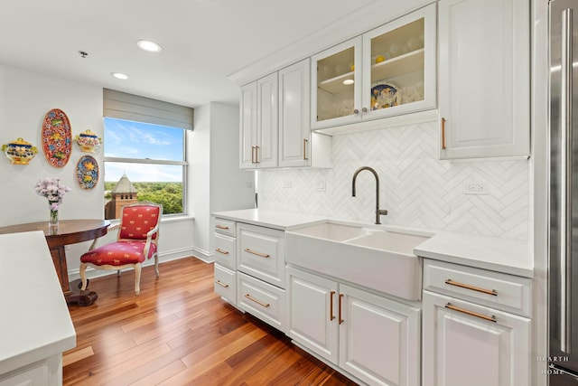 77 S Evergreen Ave Unit 1103, Arlington Heights, IL 60005 - kitchen with recessed lighting, tasteful backsplash, light countertops, light wood finished floors, and glass insert cabinets