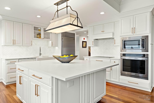77 S Evergreen Ave Unit 1103, Arlington Heights, IL 60005 - kitchen featuring built in appliances, light wood finished floors, tasteful backsplash, white cabinetry, and light countertops