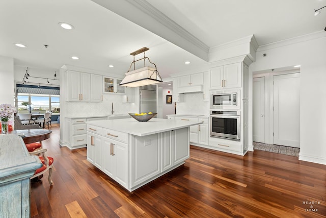 77 S Evergreen Ave Unit 1103, Arlington Heights, IL 60005 - kitchen with built in appliances, ornamental molding, dark wood-style floors, decorative backsplash, and a kitchen island