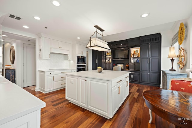 77 S Evergreen Ave Unit 1103, Arlington Heights, IL 60005 - kitchen with appliances with stainless steel finishes, light countertops, dark wood-style floors, white cabinets, and recessed lighting