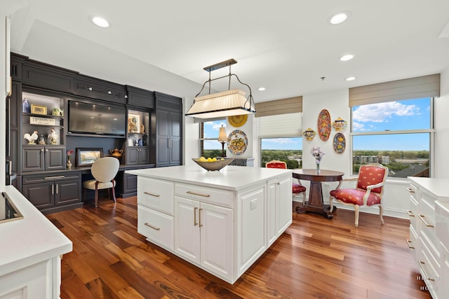 77 S Evergreen Ave Unit 1103, Arlington Heights, IL 60005 - kitchen featuring white cabinetry, light countertops, dark wood-style floors, recessed lighting, and a kitchen island