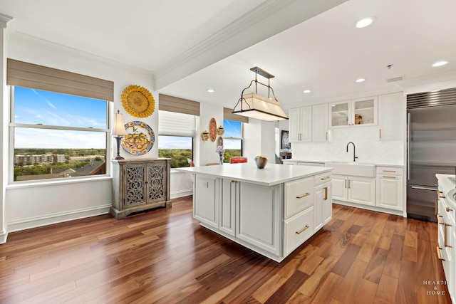 77 S Evergreen Ave Unit 1103, Arlington Heights, IL 60005 - kitchen featuring stainless steel built in fridge, ornamental molding, white cabinetry, light countertops, and a center island