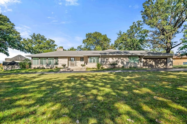 200 N Forest Ct, Addison, IL 60101 - back of house with an attached garage, a chimney, a lawn, and driveway