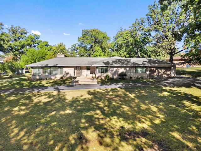 200 N Forest Ct, Addison, IL 60101 - back of property featuring a lawn, a garage, and a chimney
