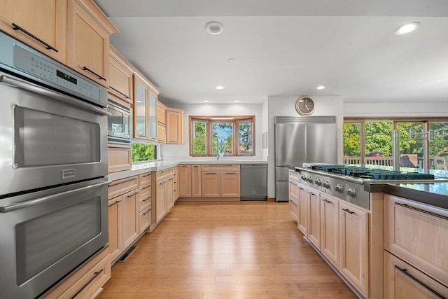 200 N Forest Ct, Addison, IL 60101 - kitchen with appliances with stainless steel finishes, light brown cabinets, light wood-type flooring, recessed lighting, and glass insert cabinets