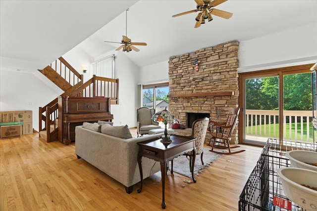 3125 Chellington Dr, Johnsburg, IL 60051 - living area featuring ceiling fan, light wood-style floors, high vaulted ceiling, stairs, and a fireplace