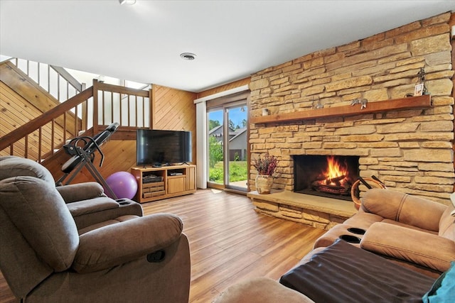 3125 Chellington Dr, Johnsburg, IL 60051 - living room featuring light wood-style flooring, a stone fireplace, and wooden walls