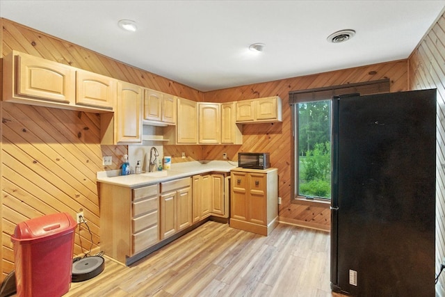 3125 Chellington Dr, Johnsburg, IL 60051 - kitchen featuring wood walls, black appliances, light brown cabinets, and light wood-style flooring