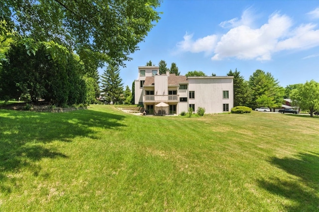3125 Chellington Dr, Johnsburg, IL 60051 - rear view of property with a balcony and a yard