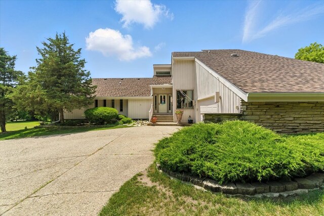 3125 Chellington Dr, Johnsburg, IL 60051 - view of front of property with an attached garage, driveway, a shingled roof, and stone siding