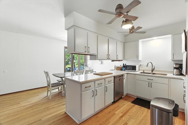 3125 Chellington Dr, Johnsburg, IL 60051 - kitchen with white microwave, stainless steel dishwasher, ceiling fan, a peninsula, and light wood-style flooring