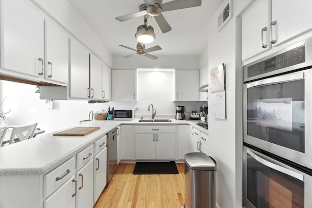 3125 Chellington Dr, Johnsburg, IL 60051 - kitchen featuring ceiling fan, stainless steel appliances, light countertops, light wood-style flooring, and white cabinetry