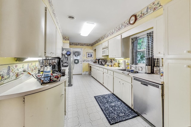 218 N Merrill St, Park Ridge, IL 60068 - kitchen with stainless steel dishwasher, white microwave, light countertops, white cabinetry, and light floors