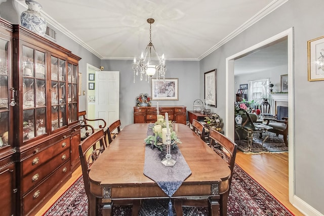 218 N Merrill St, Park Ridge, IL 60068 - dining room with wood finished floors, a chandelier, and ornamental molding