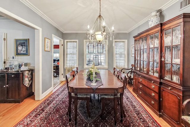 218 N Merrill St, Park Ridge, IL 60068 - dining room featuring light wood finished floors, a chandelier, and ornamental molding