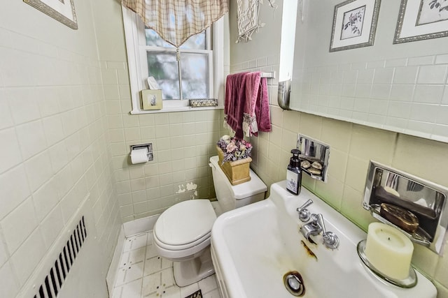 218 N Merrill St, Park Ridge, IL 60068 - half bathroom with tile walls, radiator, and tile patterned floors