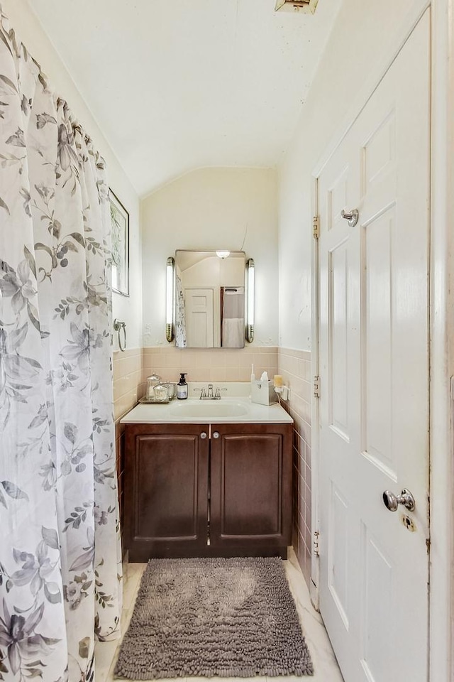 218 N Merrill St, Park Ridge, IL 60068 - full bath with tile walls, vanity, vaulted ceiling, and wainscoting