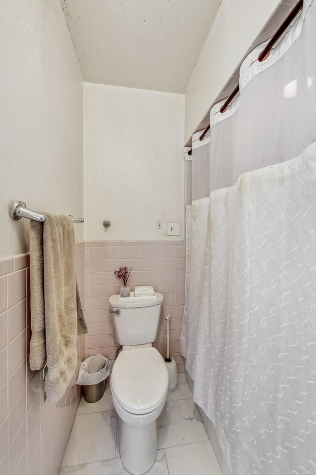 218 N Merrill St, Park Ridge, IL 60068 - bathroom featuring tile walls, wainscoting, tile patterned floors, and a shower with shower curtain