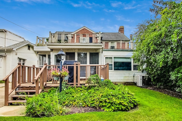 218 N Merrill St, Park Ridge, IL 60068 - view of front of house featuring a front yard, a sunroom, a deck, and brick siding
