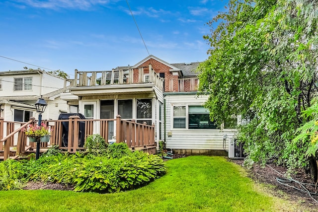 218 N Merrill St, Park Ridge, IL 60068 - rear view of house with a sunroom, a lawn, and a deck