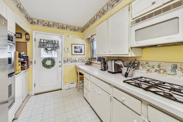 218 N Merrill St, Park Ridge, IL 60068 - kitchen with white appliances, light countertops, white cabinets, and plenty of natural light