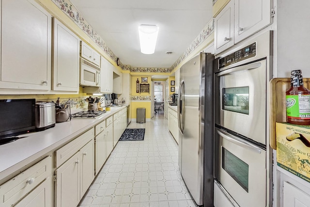 218 N Merrill St, Park Ridge, IL 60068 - kitchen featuring stainless steel appliances, light countertops, and white cabinetry