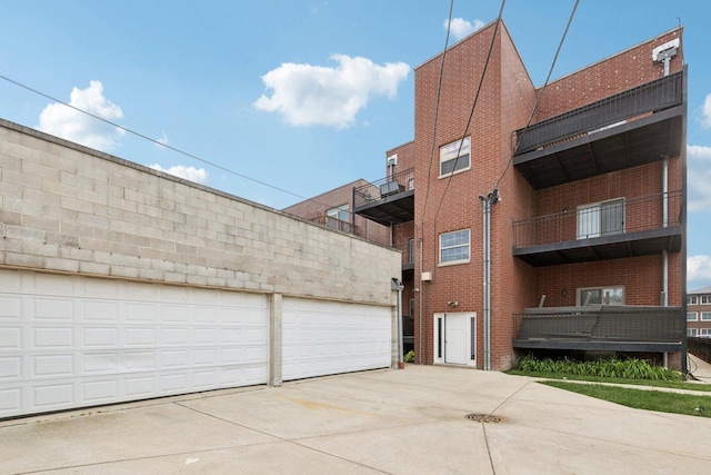 4243 N Keystone Ave Unit 2S, Chicago, IL 60641 - view of home's exterior featuring brick siding, a garage, and driveway