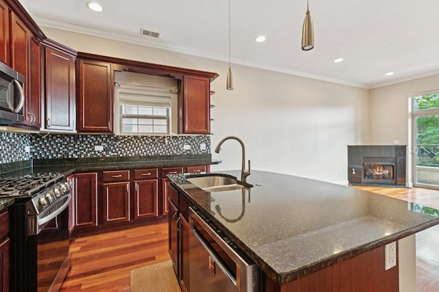 4243 N Keystone Ave Unit 2S, Chicago, IL 60641 - living room featuring wood finished floors, ornamental molding, a glass covered fireplace, and recessed lighting