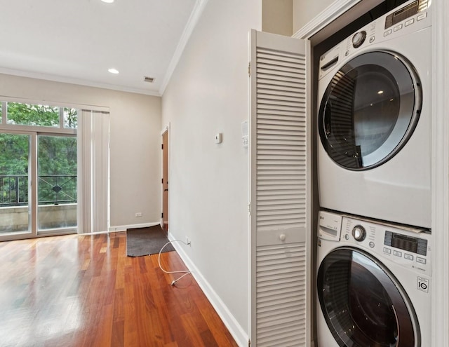 4243 N Keystone Ave Unit 2S, Chicago, IL 60641 - laundry area with stacked washer and clothes dryer, ornamental molding, wood finished floors, and recessed lighting