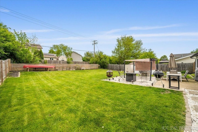 2009 Chaplin Ct, Hanover Park, IL 60133 - fenced backyard with an outdoor fire pit and a patio area