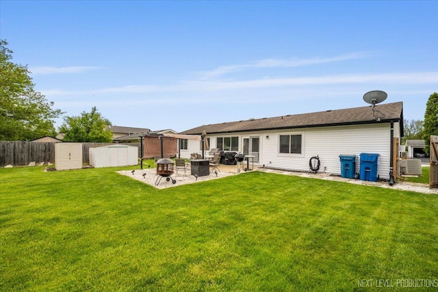 2009 Chaplin Ct, Hanover Park, IL 60133 - back of house with an outdoor fire pit, a patio, and a storage shed