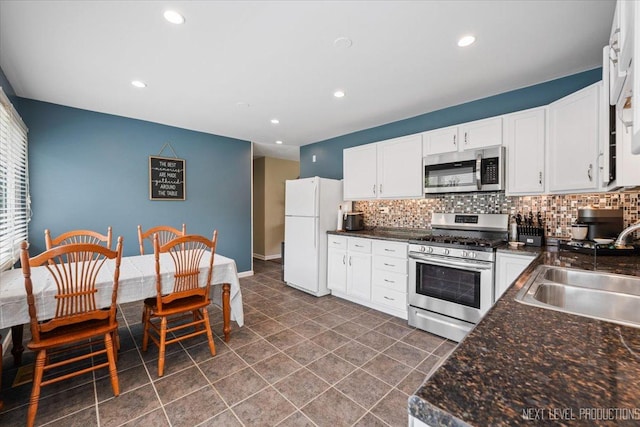 2009 Chaplin Ct, Hanover Park, IL 60133 - kitchen with appliances with stainless steel finishes, decorative backsplash, dark countertops, and recessed lighting