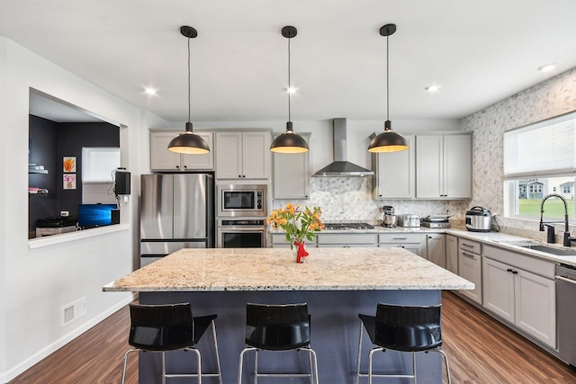 3620 Ambrosia Dr, Naperville, IL 60564 - kitchen featuring wall chimney range hood, stainless steel appliances, a kitchen island, a breakfast bar area, and recessed lighting