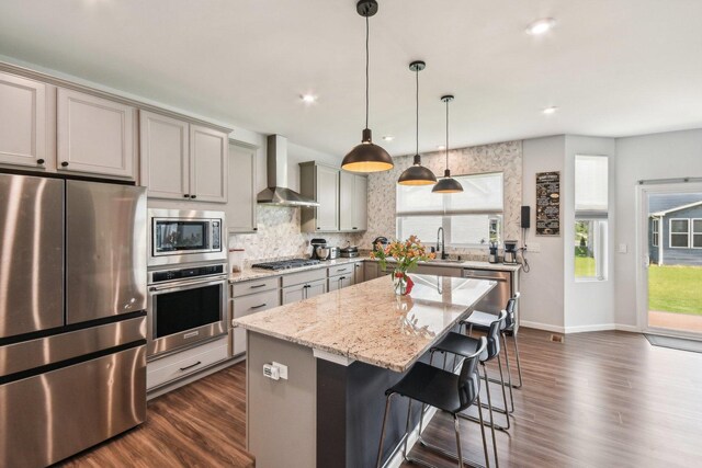 3620 Ambrosia Dr, Naperville, IL 60564 - kitchen with stainless steel appliances, wall chimney range hood, gray cabinets, dark wood-style floors, and backsplash